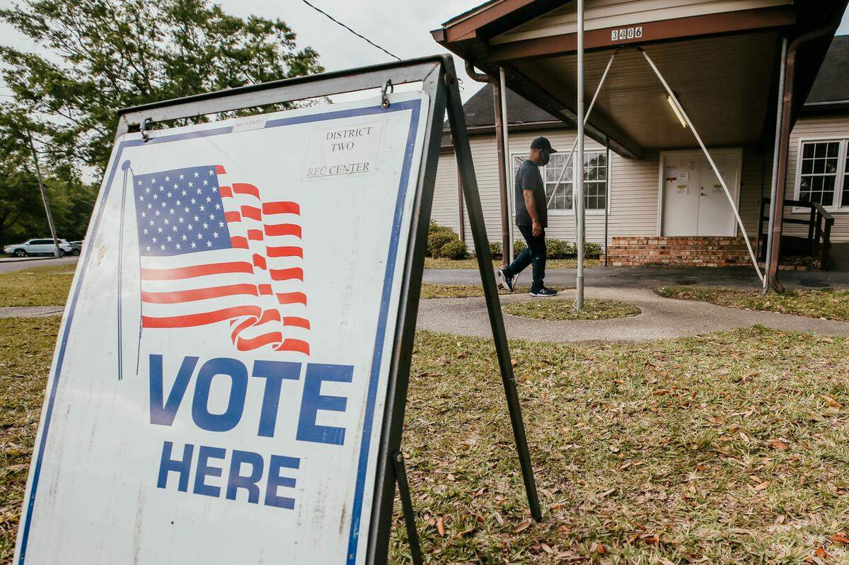 A masked voter walks into the Young Men’s Business Club polling site to vote in the municipal primary elections Tuesday, April 6, 2021 in Moss Point, Mississippi.