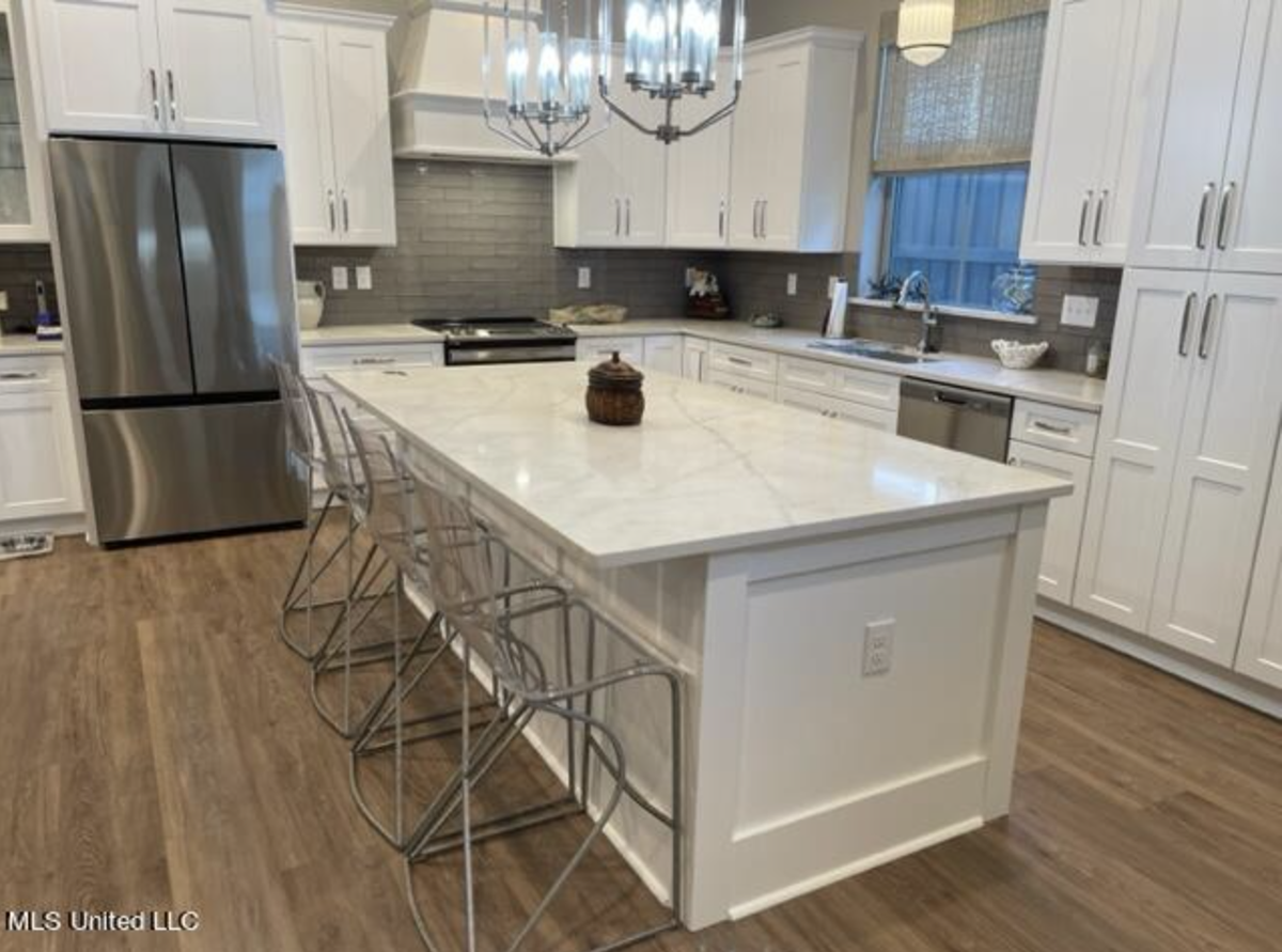 The kitchen in a house listed for $499,900 in The Courtyards at Dunbar features custom cabinets, an island and quartz countertops.