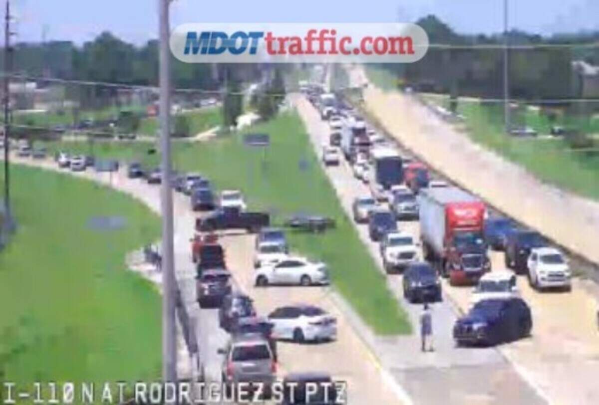 Drivers attempting to cross the I-110 bridge are directed away from the scene Friday, June 19, 2026.