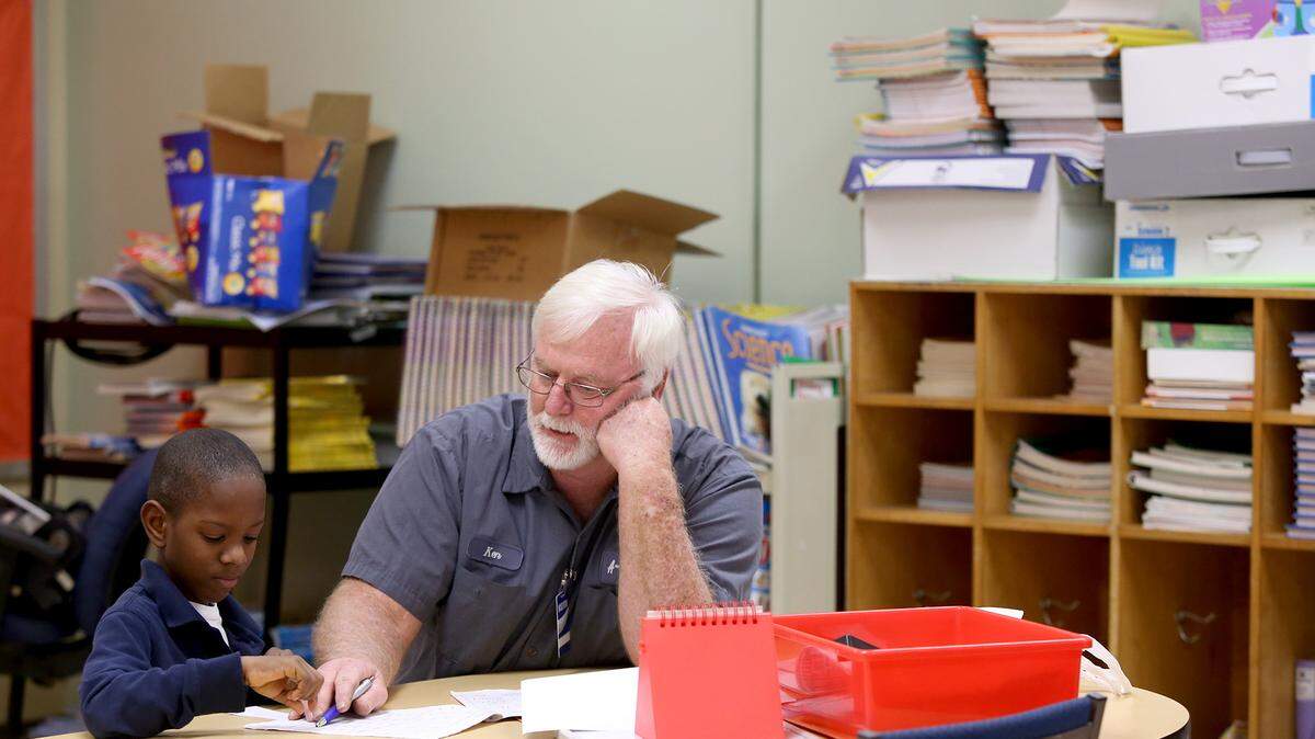 AMANDA McCOY/SUN HERALDKen Turner, right, tutors Kreole Elementary second-grader Dorian Johnson on Feb. 24 in Moss Point. Turner and his wife, Sheila, tutor at the school four days a week. They take turns going on their lunch break to help students with their reading.