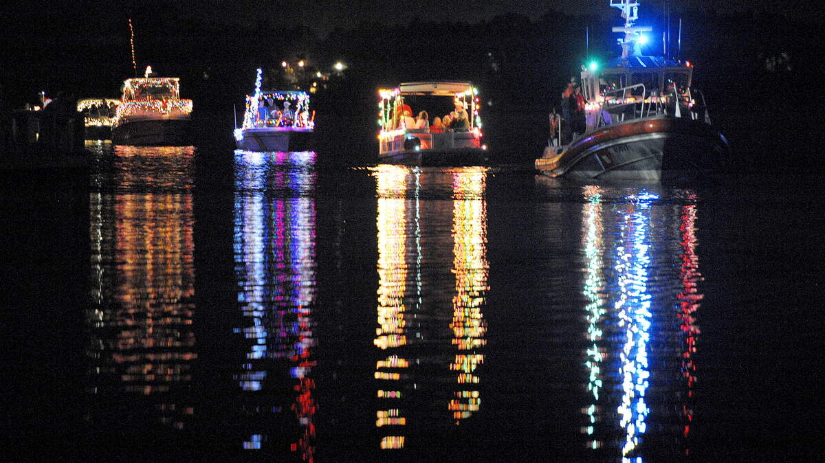 Led by a U.S. Coast Guard boat, at right, participants spread cheer in the annual Moss Point Christmas by the River, sponsored by the Moss Point Active Citizens. This year's event is Saturday.
