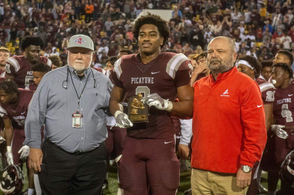 Picayune running back Dante Dowdell, center, poses for a photo with his MVP trophy following Picayune’s win over West Point in the 5A State Championship game at M.M. Roberts Stadium in Hattiesburg on Saturday, Dec. 4, 2021.