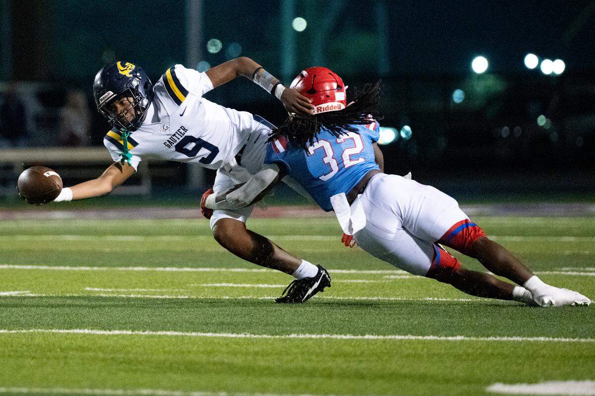 Gautier quarterback Keon McNeil (9) is sacked by Pascagoula linebacker Creevy Harness (32) during a football game at Pascagoula High School on Thursday, Nov. 6, 2025.