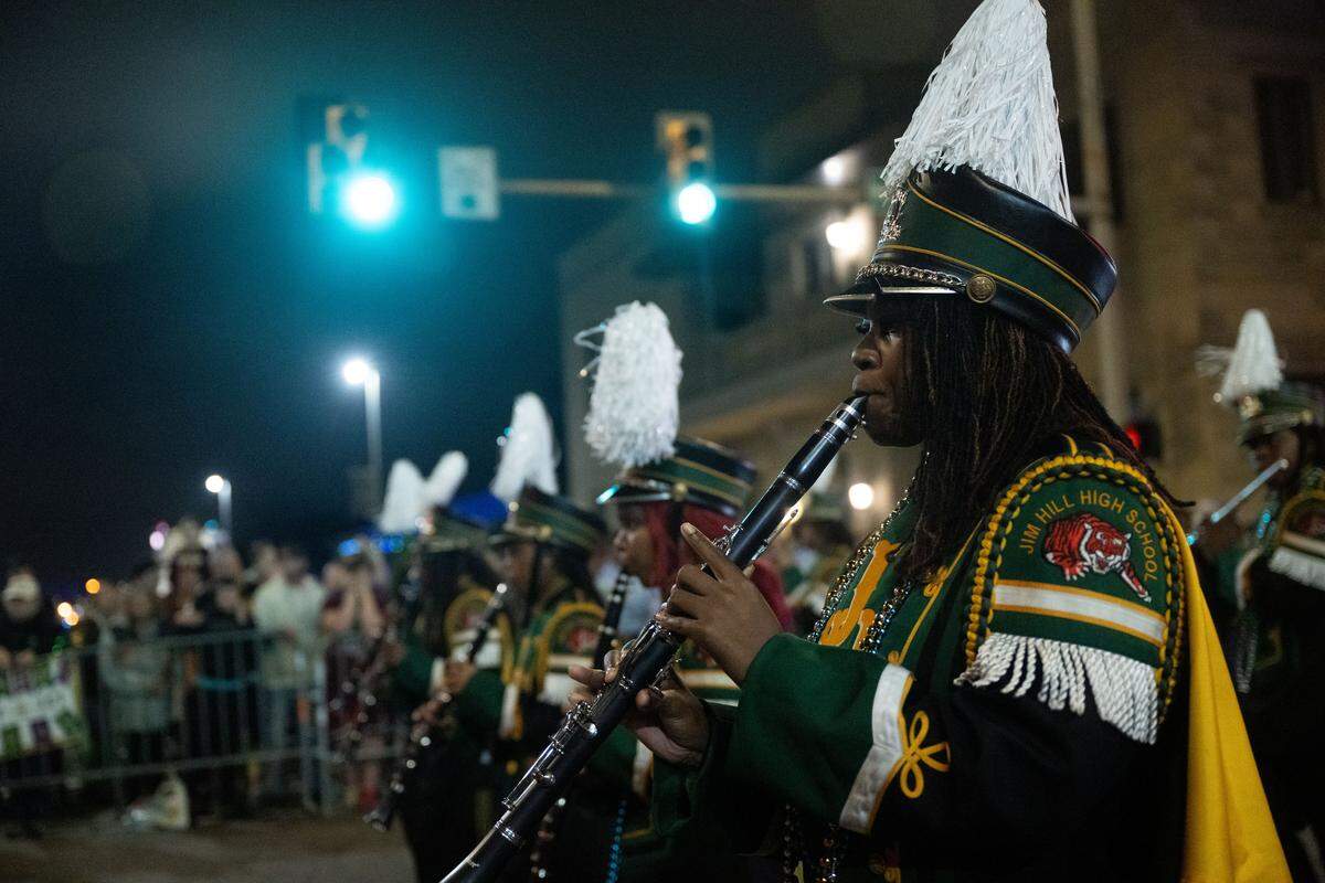 Clarinet players from the Jim Hill High School marching band march down Howard Avenue during the Krewe of Neptune parade in Biloxi on Saturday, Feb. 14, 2026.