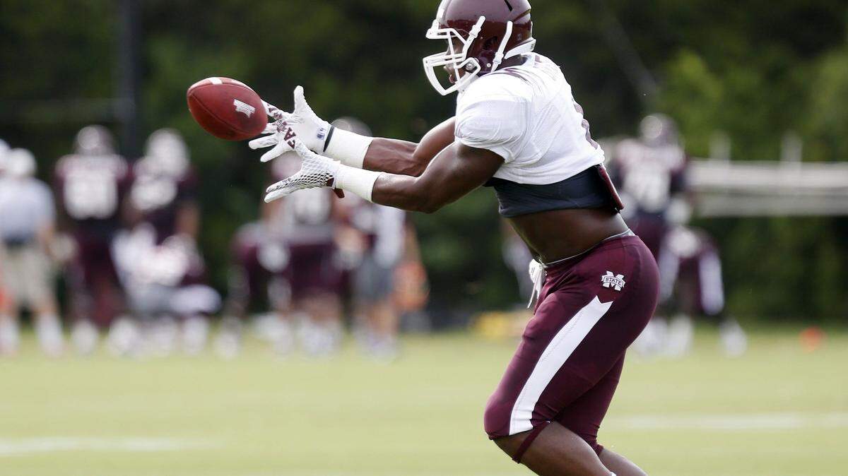 Mississippi State linebacker Gerri Green reaches for a pass during a drill at an NCAA college football practice in Starkville, Miss., Friday, Aug. 7, 2015. (AP Photo/Rogelio V. Solis)