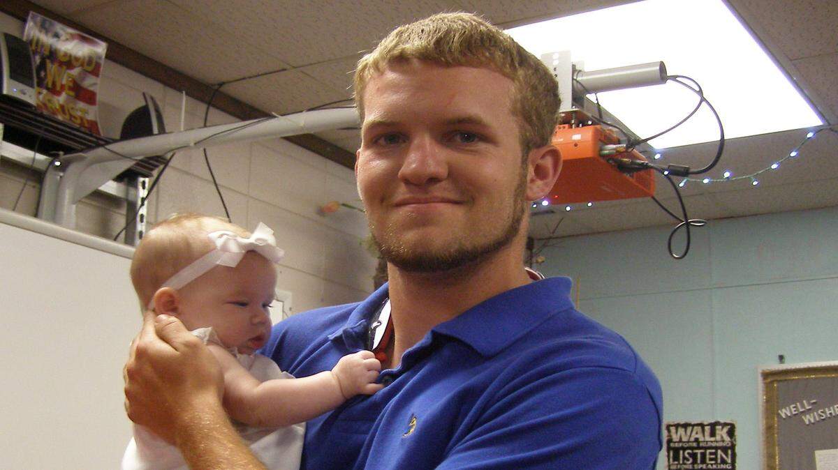 JUSTIN VICORY/SUN HERALDTaylor Brazell holds Presley Furby, the youngest of three children he helped rescue after a crash.