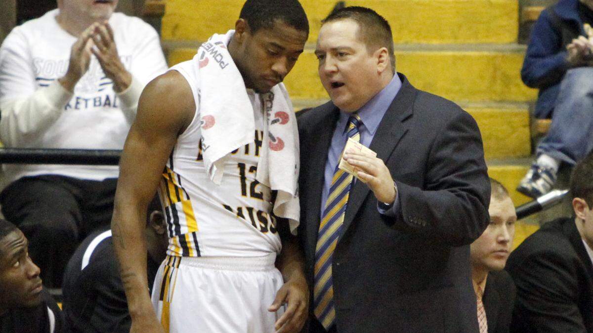 TIM ISBELL/SUN HERALD 
 Southern Miss coach Donnie Tyndall talks with guard Deonte Houston during the 2013-14 season in Hattiesburg.