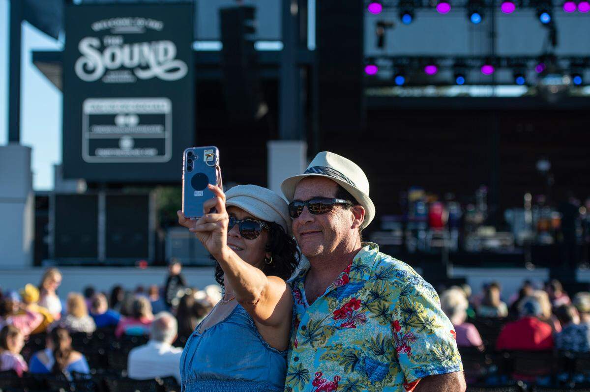 Fans take selfies before the start of the KC and The Sunshine Band concert at The Sound Amphitheater in Gautier on Friday, April 12, 2024. The show marks the multi-million dollar venue’s inaugural show.