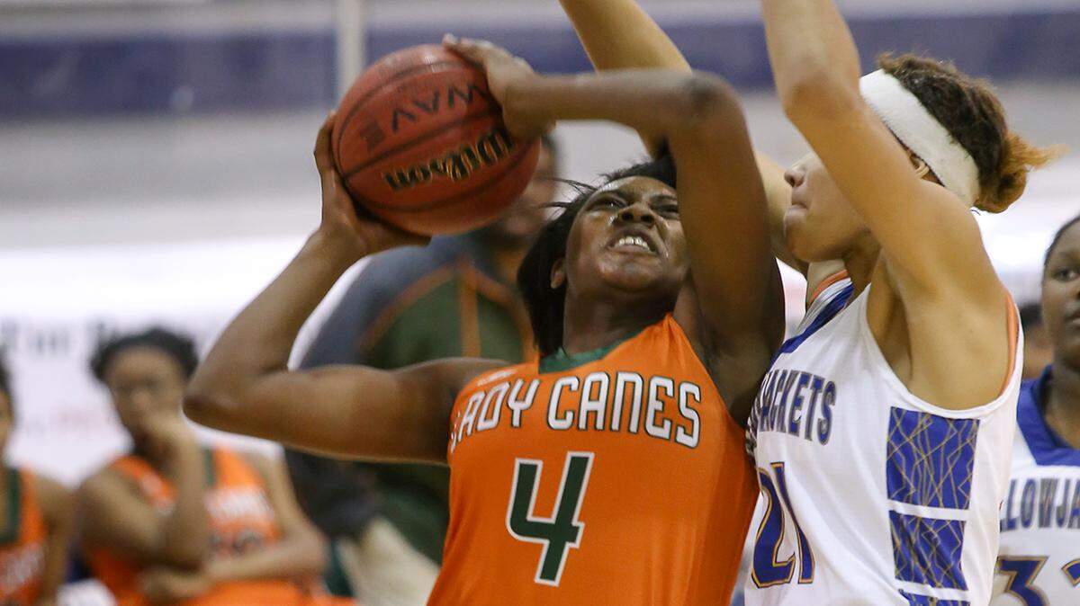AMANDA McCOY/SUN HERALDWest Harrison's Ameshya Williams attempts a basket while guarded by St. Martin's Daphane White on Tuesday, December 8, 2015, at St. Martin High. St. Martin defeated West Harrison, 64-41. 