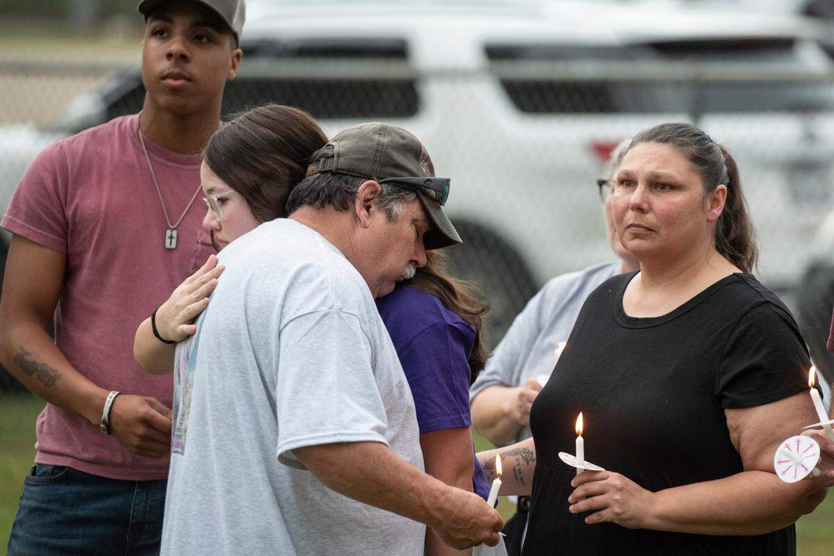 Billy Wedgeworth, Gracelynn’s uncle, hugs family members during a candlelight vigil in remembrance of Gracelynn Vick at Saucier Park on Tuesday, April 22, 2025.