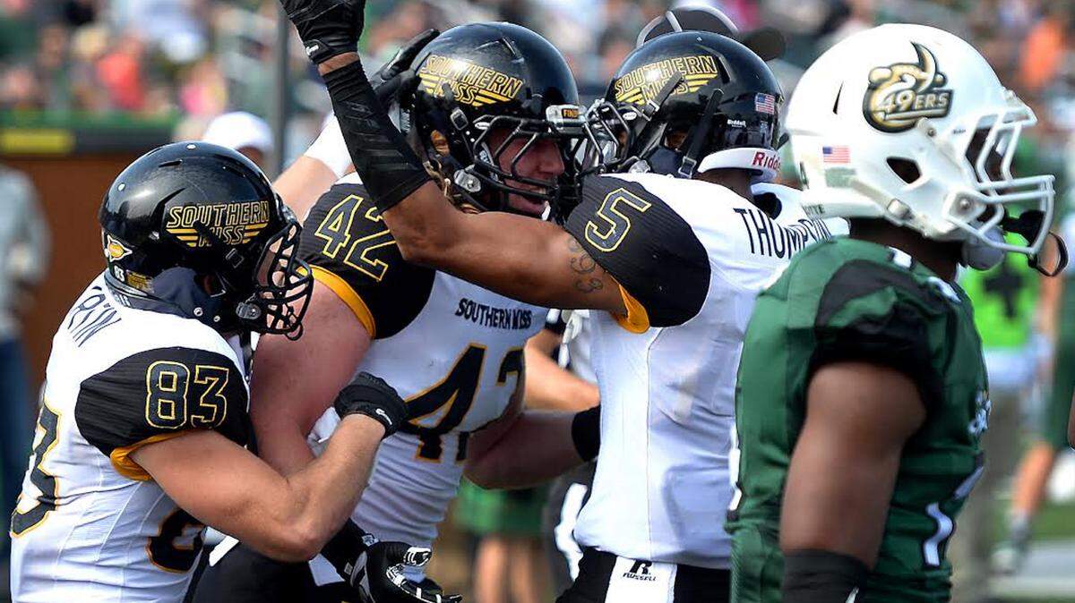 Southern Miss tight end Taylor Marini, center, is congratulated by wide receivers Casey Martin, left, and D.J. Thompson after he caught a batted ball for a touchdown during second quarter action vs the Charlotte 49ers at Jerry Richardson Stadium on Saturday, October 24, 2015.