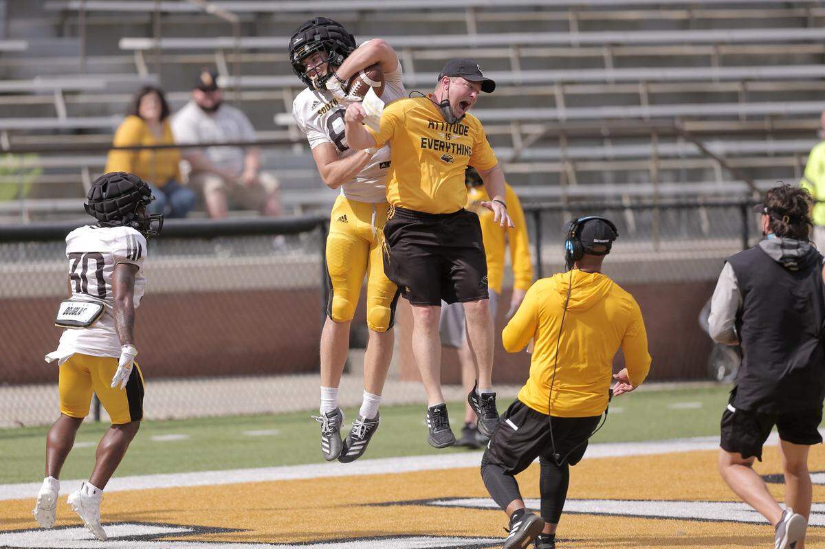 Southern Miss head coach Will Hall celebrates a one-handed grab in the end zone from freshman tight end Luke Baker during the Golden Eagle’s spring scrimmage Saturday, March 28, 2021.