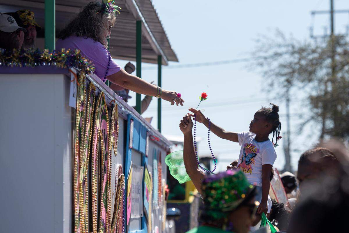 Krewes toss beads and other throws during the Jackson County Carnival Association Mardi Gras parade in Pascagoula on Saturday, March 1, 2025.