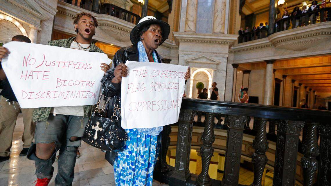 Ineva May-Pittman, right, of Jackson, Miss., leads a chanting flash protest around the Capitol rotunda in Jackson, Miss., Monday, April 4, 2016. May-Pittman was killed in a house fire Jan. 3, 2023. (AP Photo/Rogelio V. Solis)