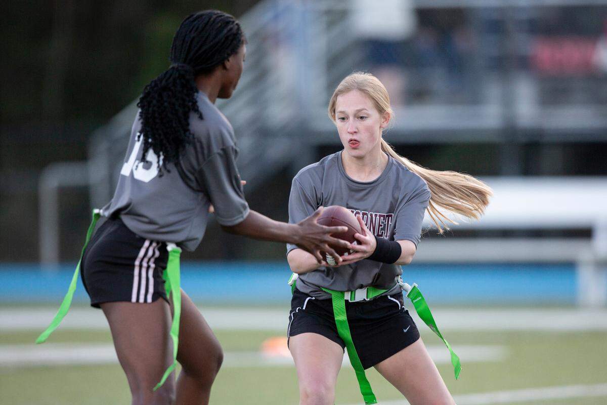 East Central’s Olivia Tanner hands the ball off to Taliyah Nichols during a Jamboree game at Vancleave on Thursday, March 20, 2025.