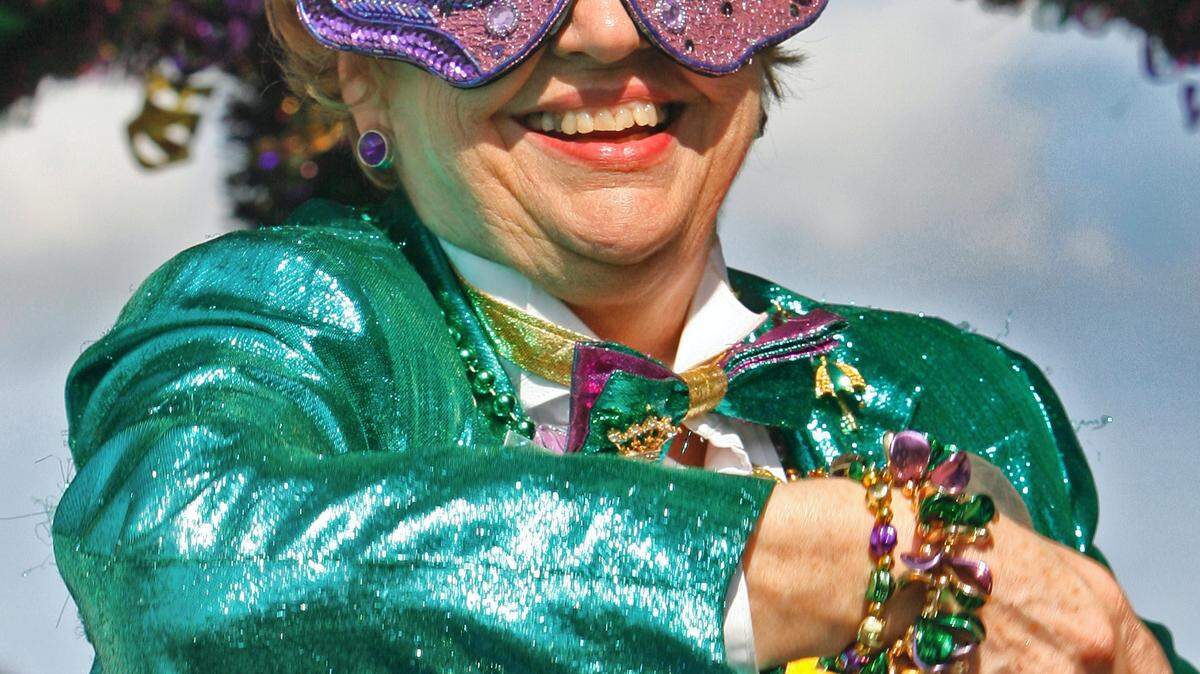 SUN HERALD/FILEA member of the Krewe of Do Dah throws a string of beads during a previous Jackson County Carnival Association parade in Pascagoula. See the full list of South Mississippi events for this week's Mardi Gras parade times.