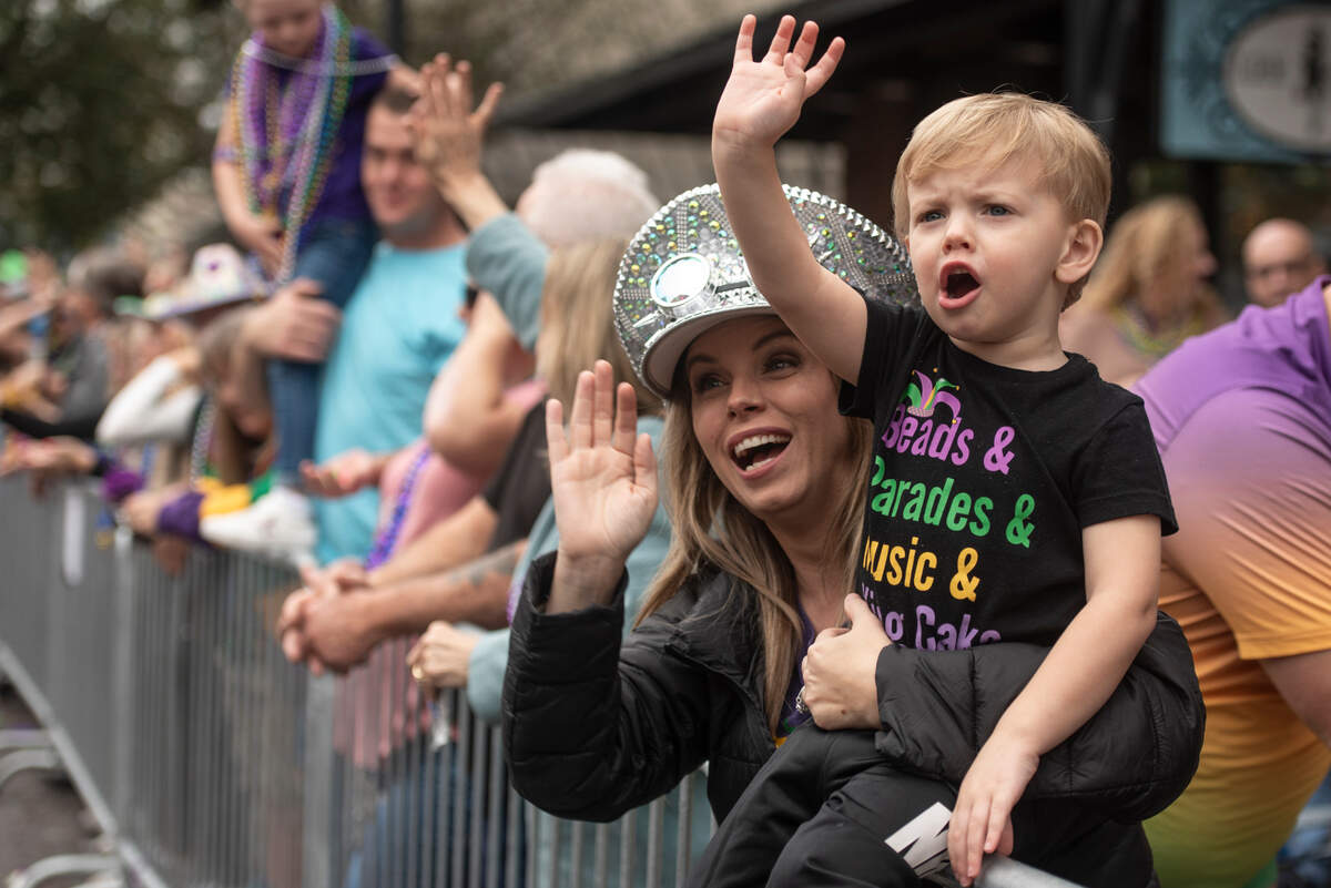 Parade attendees cheer for beads during The Ocean Springs Elks Carnival Parade in downtown Ocean Springs on Saturday, Jan. 27, 2024.
