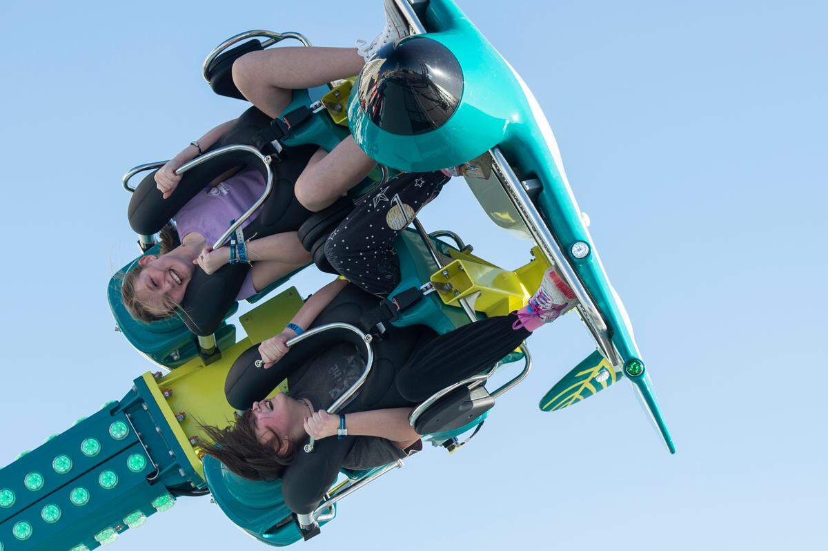 Riders react as they ride the Puddle Jumper ride at Paradise Pier amusement park at Margaritaville Resort Biloxi.