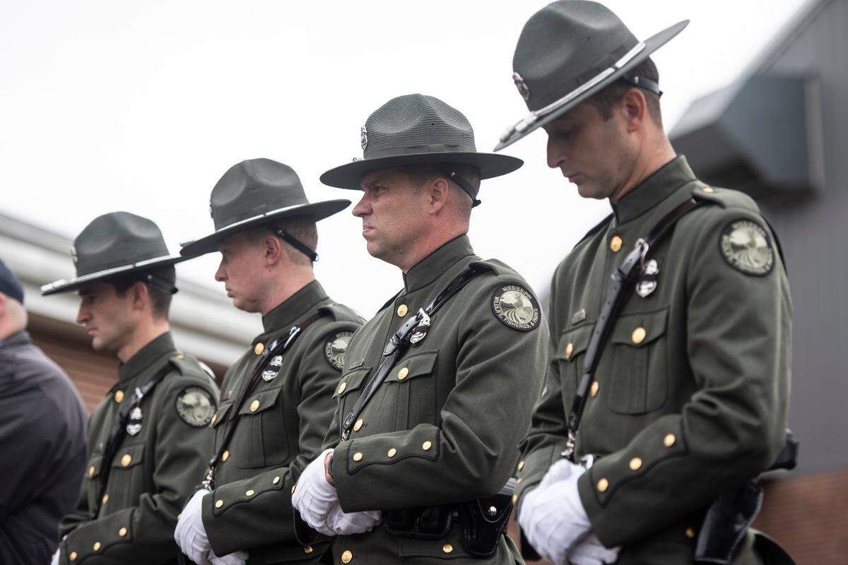 Members Mississippi Wildlife and Fisheries Department stand by as of law enforcement officers carry the casket of George County Sheriff’s Deputy Jeremy Malone to the hearse following Malone’s funeral at Agricola Baptist Church in George County on Friday, Jan. 12, 2024.