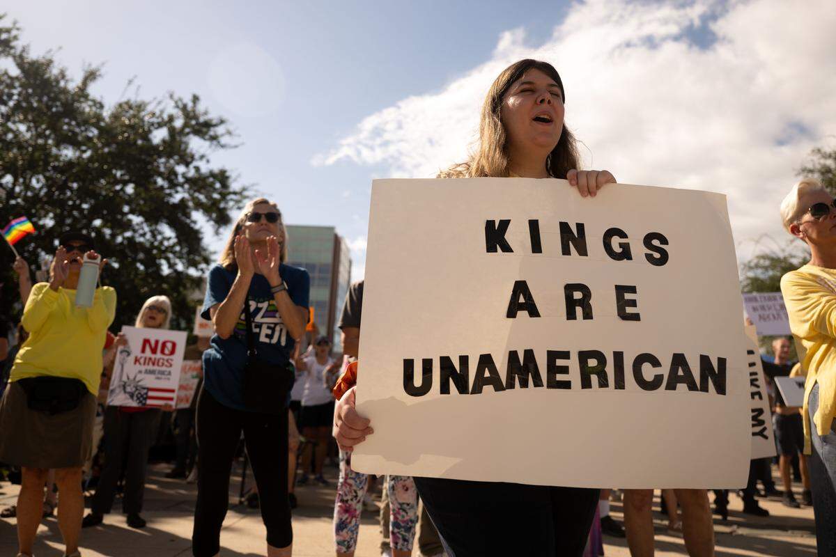 Protesters chant with signs during the No Kings protest in Gulfport.