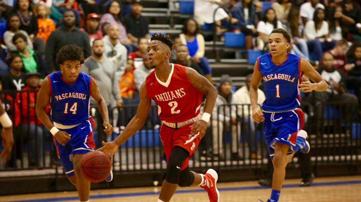 AMANDA MCCOY/THE SUN HERALD 
 Biloxi's Martell Turner dribbles the ball followed by Pascagoula's Eric Smith, left, and Jonas Burley at the Gulfport Hardwood Holiday Classic on Wednesday at Bert Jenkins Gymnasium.