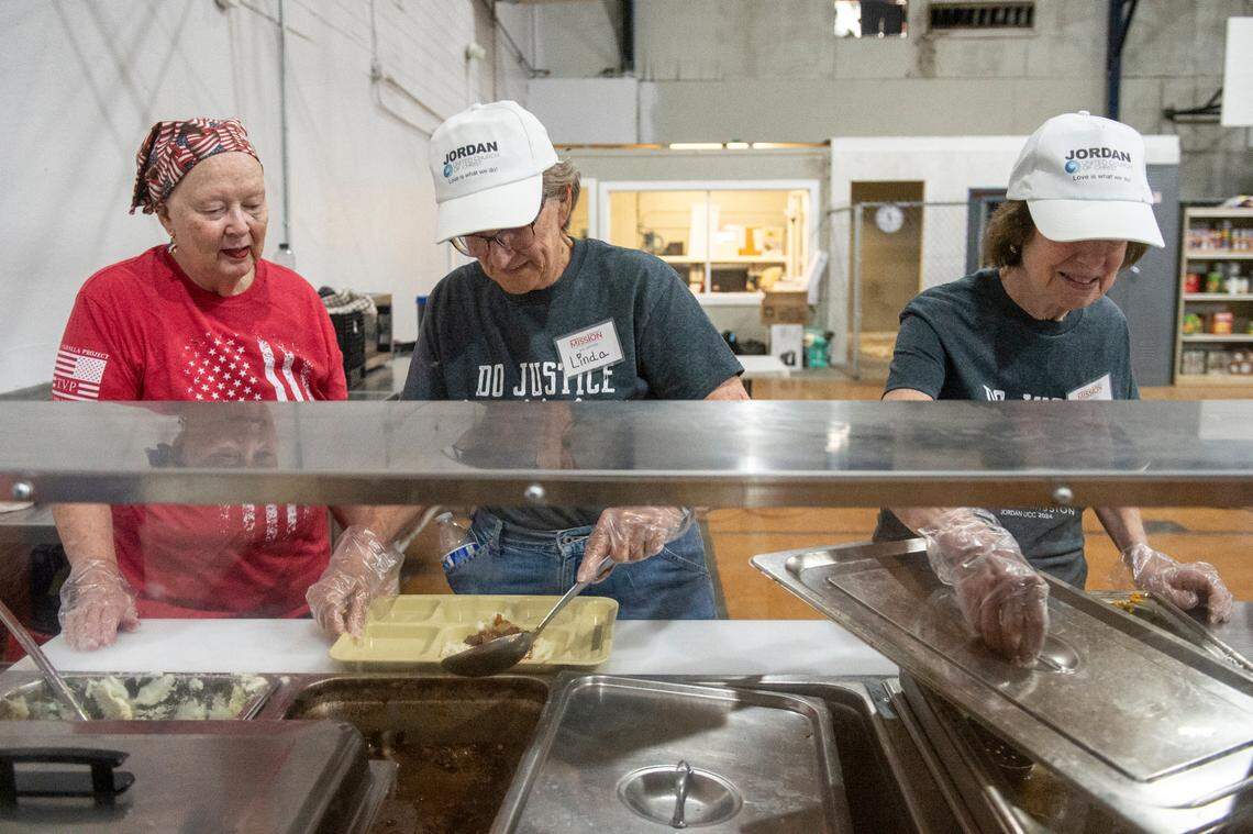 Volunteers from Jordan United Church of Christ in Allentown, Pa. serve lunches with Loaves and Fishes — a nonprofit serving those in need — at the former Mercy Cross High School in Biloxi on Tuesday, May 14, 2024. Loaves and Fishes will be one of a number of nonprofits working out of the old school’s gym as a part of Mercy Cross Center, which will serve as a resource for unhoused people and families.