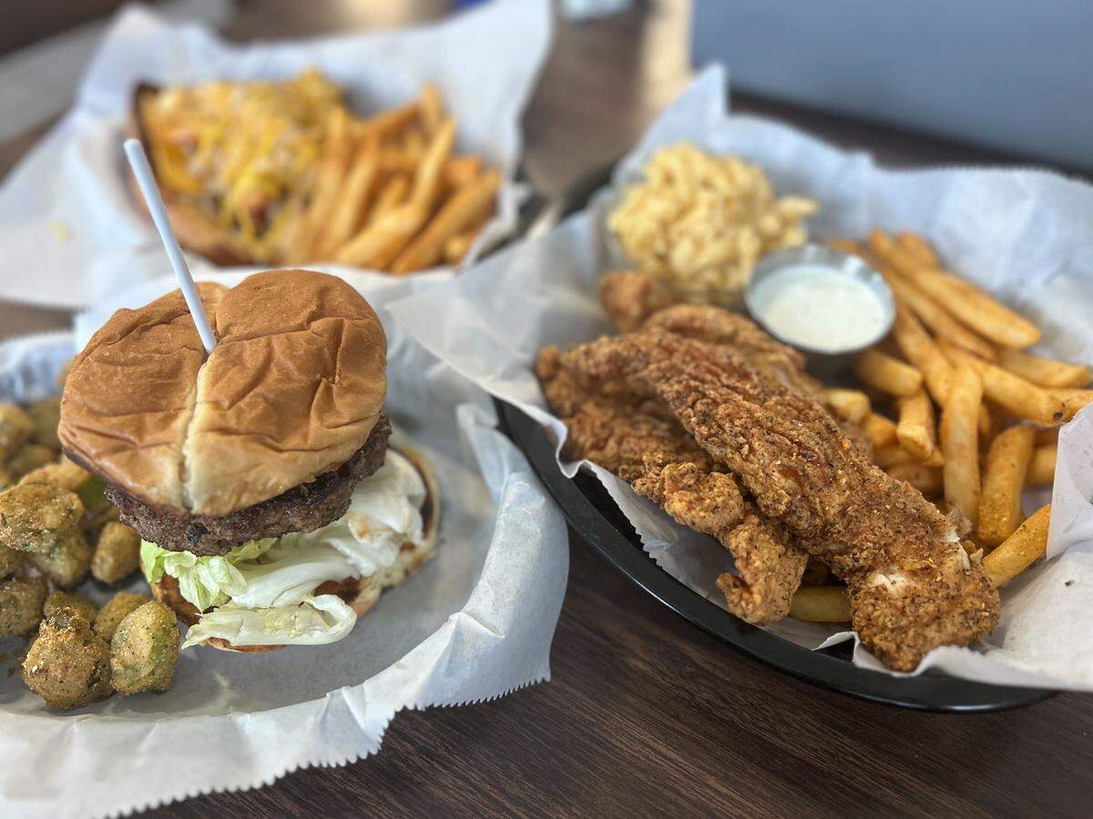 The crawfish burger and chicken tender plate at PB’s Twisted “Q” in McHenry, South Mississippi.