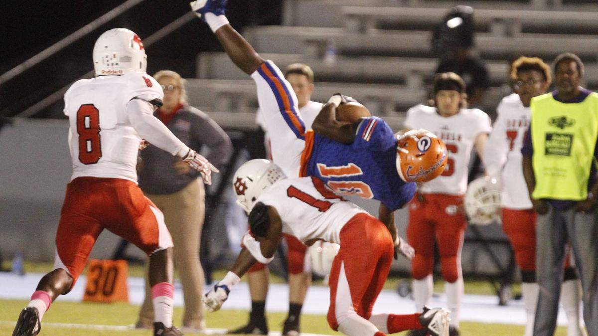 Gulfport wide receiver Tommie Johnson is tackled by Harrison Central corner back Azhani Ray during the second quarter of their game at Milner Stadium in Gulfport on Friday, Oct. 12, 2018.