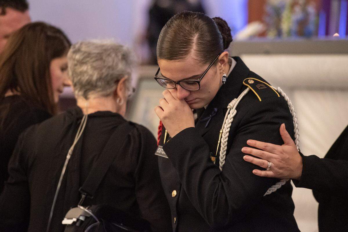 Lily Estorffe reacts after saying her final goodbye to her brother before the casket is closed during the funeral of Bay St. Louis police officers Sgt. Steven Robin and Branden Estorffe at the Bay St. Louis Community Center in Bay St. Louis on Wednesday, Dec. 21, 2022. Robin and Estorffe were killed responding to a call at a Motel 6 on Dec. 14.