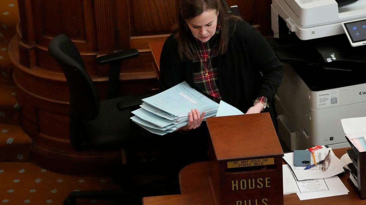 Hunter Dowdy, Assistant Clerk of the Mississippi House of Representatives, collects filed House bills Wednesday in the chamber at the Mississippi State Capitol.