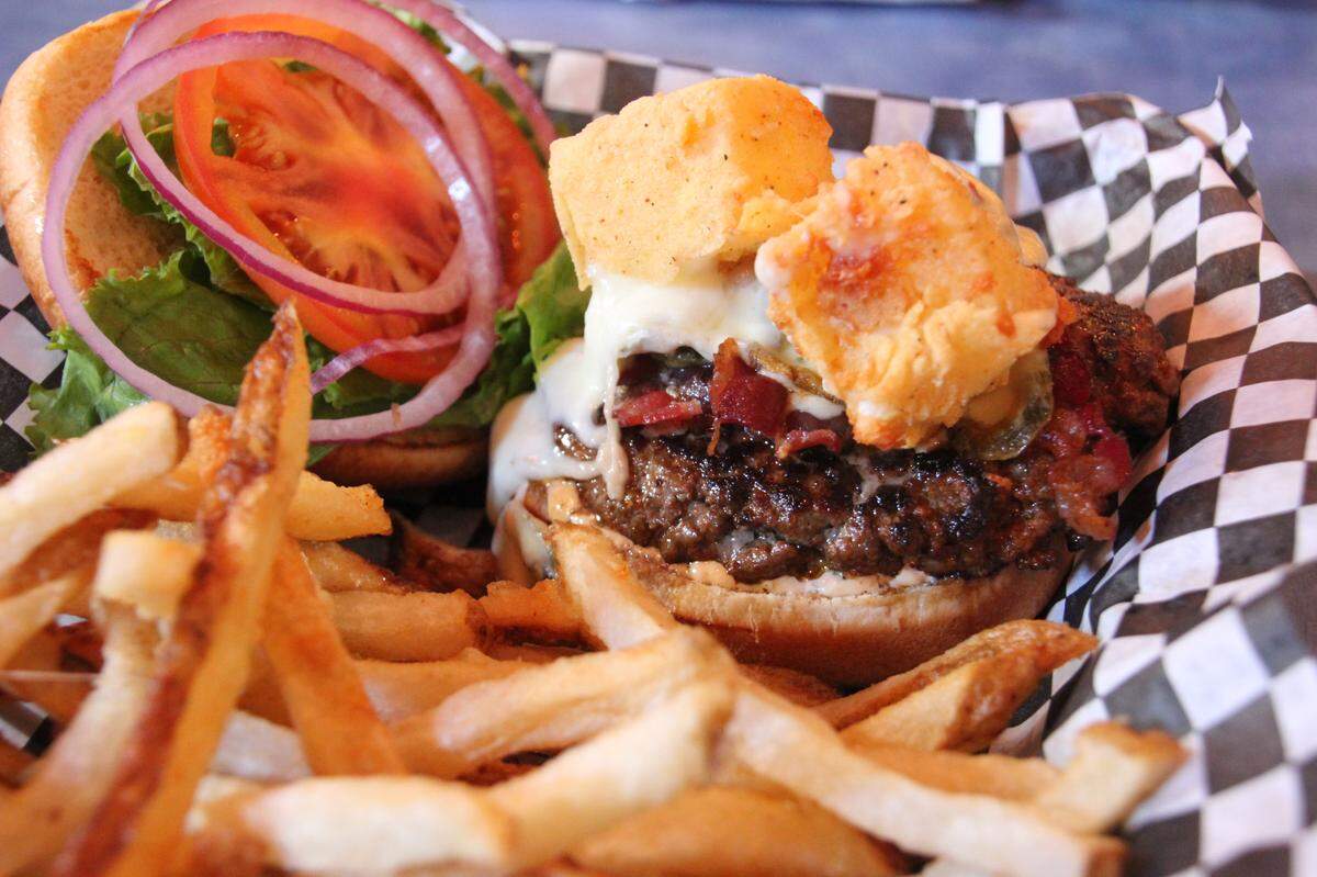 Big Ben burger with blue cheese, along with salads and fish tacos are the specialties at Woody’s Roadside, now open on Cowan Road in Gulfport.