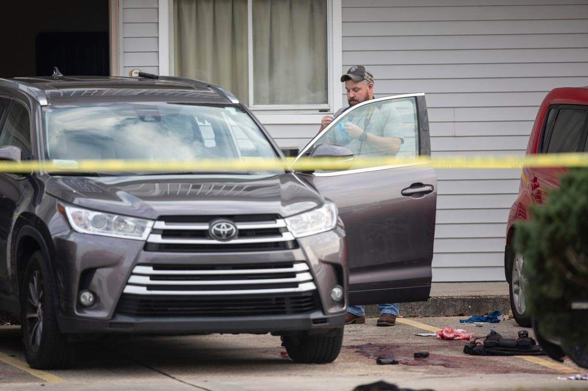 An investigator photographs inside a Toyota that Amy Borgdon Anderson was driving parked outside the Motel 6 in Bay St. Louis on Wednesday, Dec. 14, 2022.