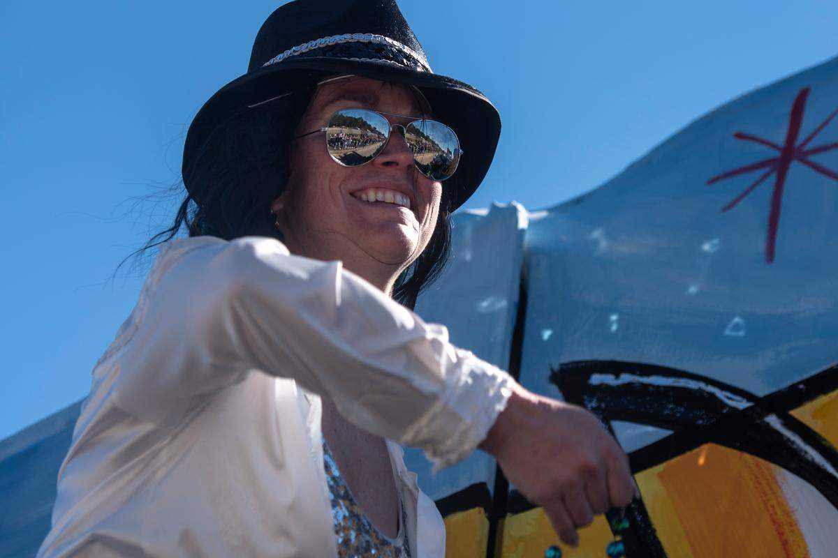 A float rider tosses beads to the crowd during the Krewe of Nereids Mardi Gras parade on Highway 90 in Bay St. Louis on Sunday, Feb. 12, 2023.