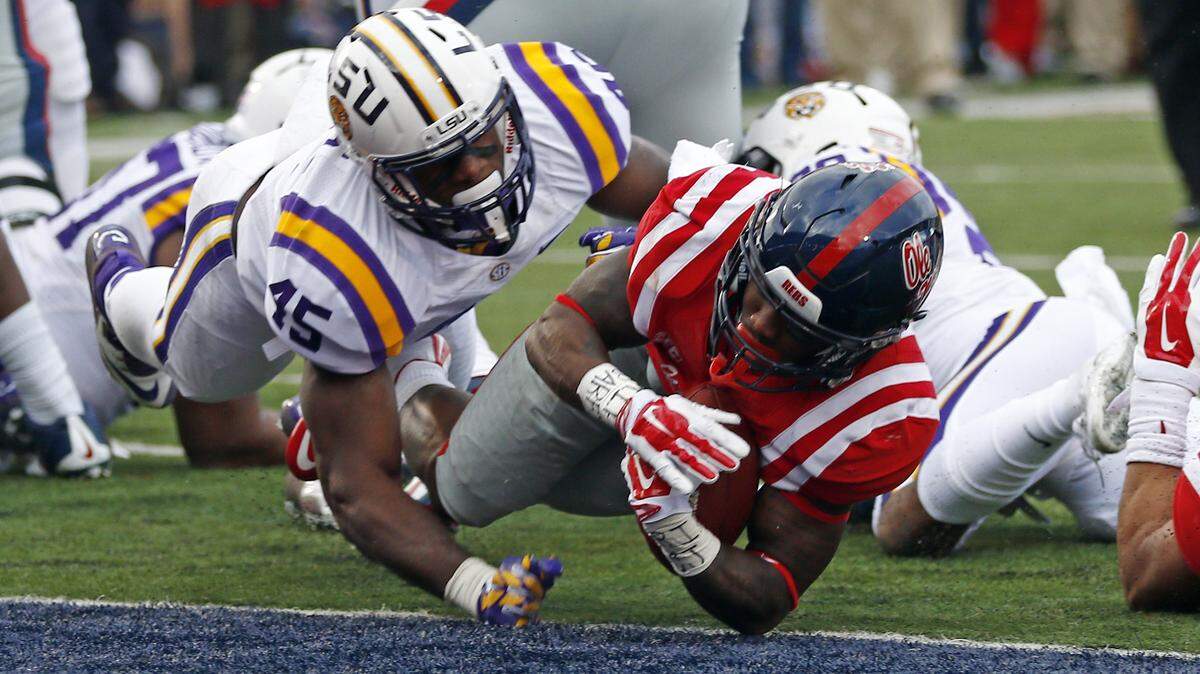 Mississippi running back Jaylen Walton (6) stretches past LSU linebacker Deion Jones (45) for a 2-yard touchdown run in the first half of an NCAA college football game in Oxford, Miss., Saturday, Nov. 21, 2015. (AP Photo/Rogelio V. Solis)
