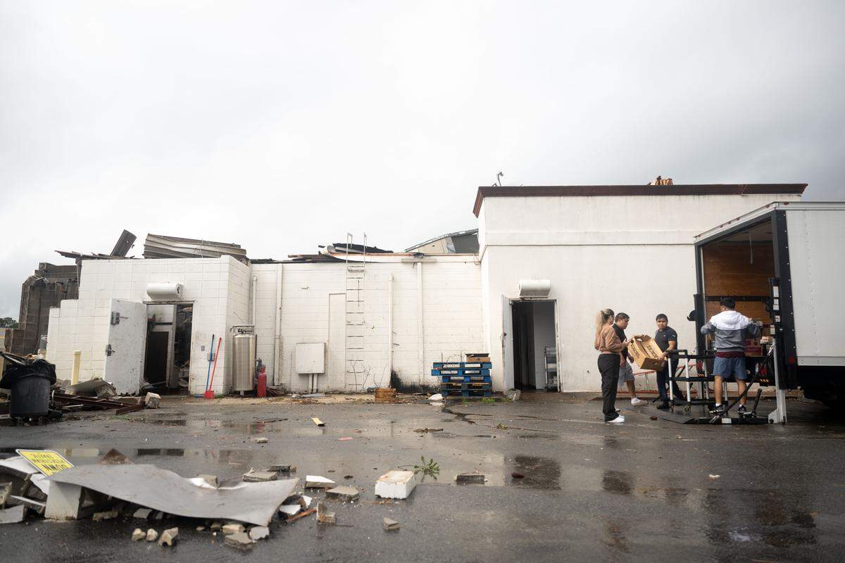 Workers salvage remaining food from Aztecas Restaurant & Cantina after tornadoes struck Oct. 26 across South Mississippi.