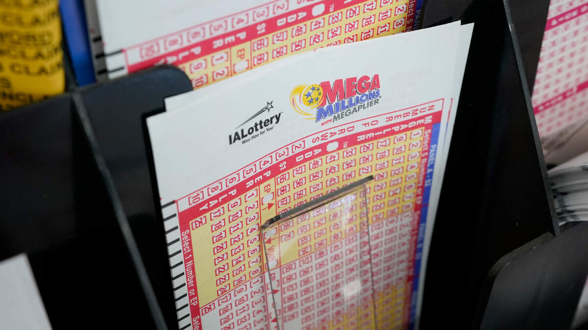 Blank forms for the Mega Millions lottery sit in a bin at a local grocery store, Tuesday, Jan. 12, 2021, in Des Moines, Iowa. Lottery players have a chance to win the largest jackpots in nearly two years as Tuesday’s Mega Millions has grown to an estimated $625 million and Wednesday’s Powerball to an estimated $550 million.