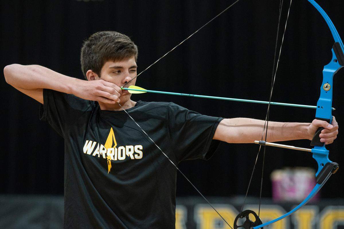 Senior Landon Garrett, a member of the D’Iberville High School archery team, aims his shots during a practice at D’Iberville High School on Thursday, April 18, 2024.