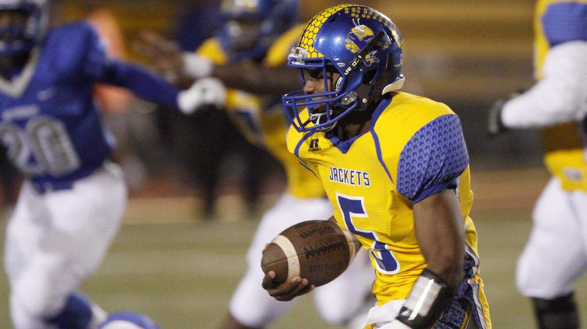 TIM ISBELL/SUN HERALD 
St. Martin's Tyler Polk sweeps around end for a first down against Ocean Springs, Friday, Oct. 23, 2015.