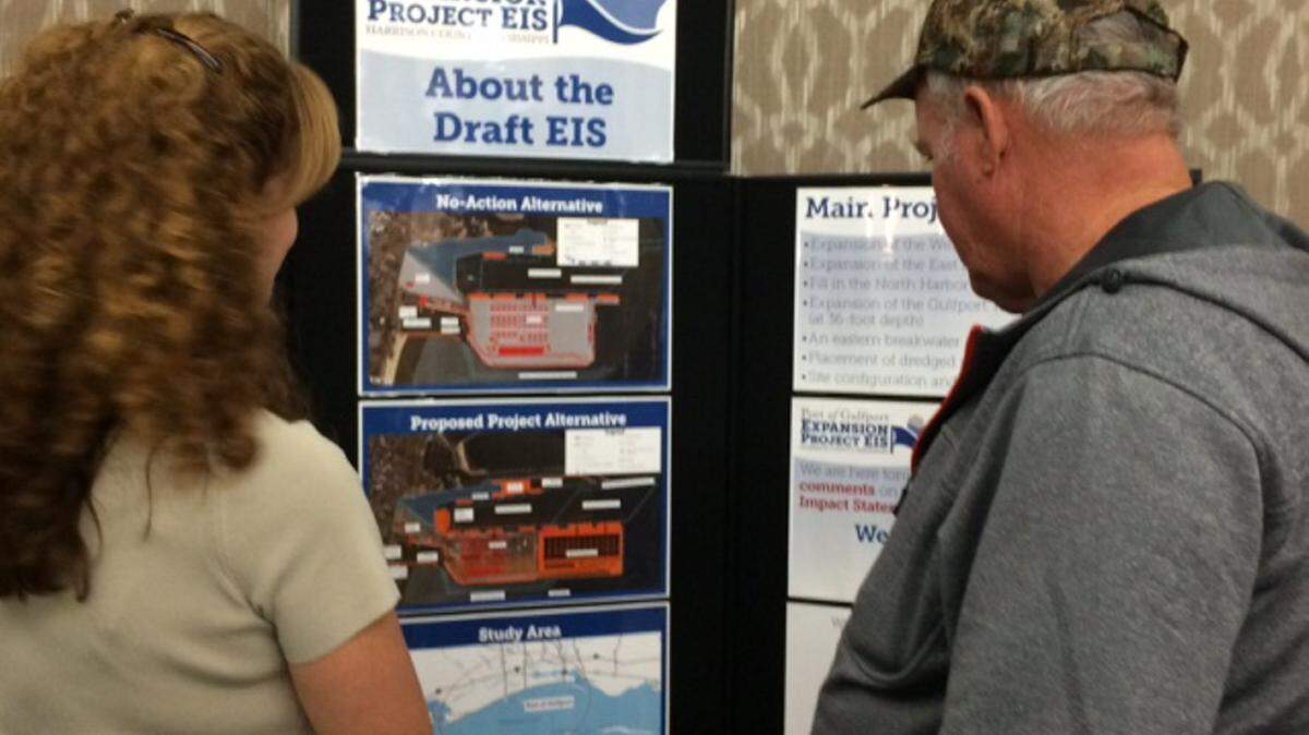 ANITA LEE/SUN HERALD 
 A representative who worked on a U.S. Army Corps of Engineers study on the environmental impact of state port expansion, left, answers questions for a resident who attended a public hearing Tuesday night about the study.