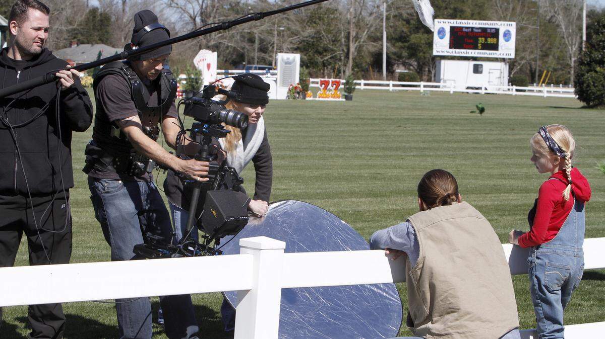 TIM ISBELL/SUN HERALD 
 Michael Anglin works sound as Derek Bradley films a scene of the Majestic being filmed at the Gulf Coast Classic, Wednesday, Feb. 10, 2016. Director Rachel Gordon holds a reflector as actors Cy Parks and Mary Powers recite their lines.