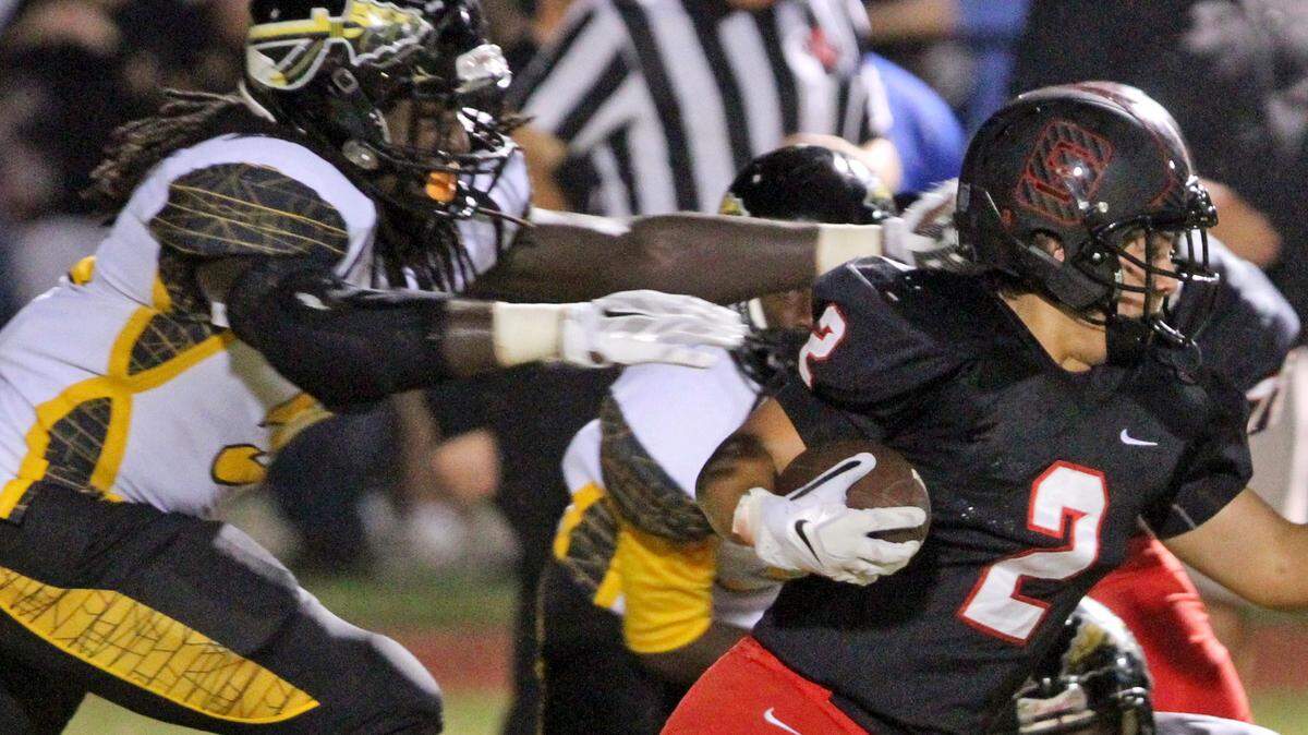 JOHN FITZHUGH/SUN HERALD 
 D'Iberville defensive end Jacques Turner reaches out to tackle St. Stanislaus' Cahill Marlowe in Bay St. Louis on Sept. 18.
