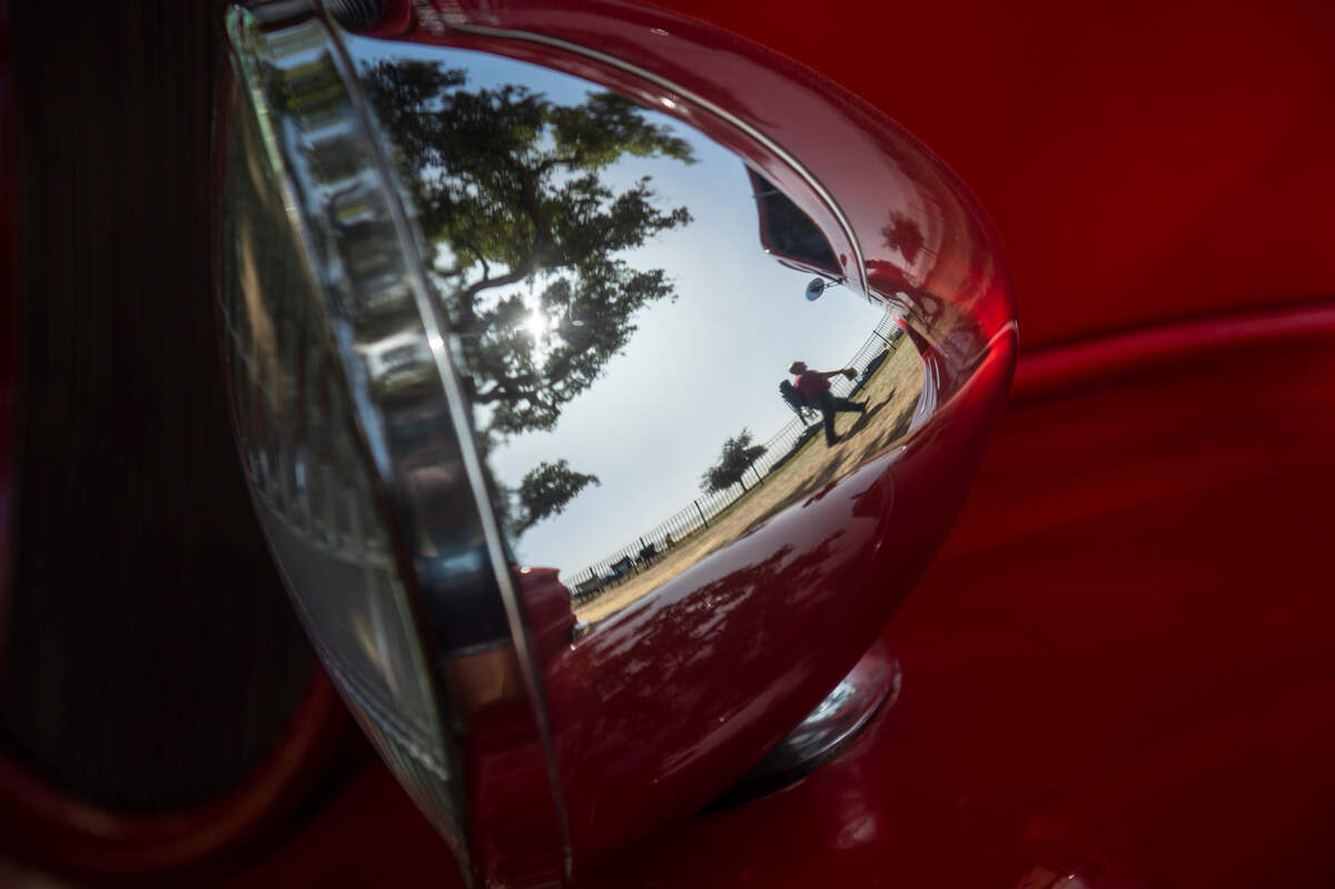 Spectators walk past cars at Cruisin’ Central at Centennial Plaza during Cruisin’ the Coast on Tuesday, Oct. 3, 2023.