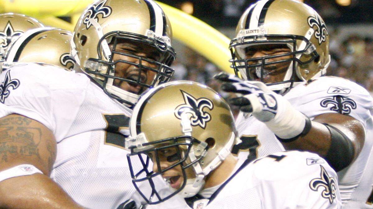 New Orleans Saints wide receiver Lance Moore (16) celebrates scoring the game winning touchdown with teammates Jonathan Goodwin, left, and Jermon Bushrod during the fourth quarter of an NFL football game against the Dallas Cowboys, Thursday, Nov. 25, 2010, in Arlington, Texas. The Saints won 30-27. (AP Photo/Mike Fuentes)