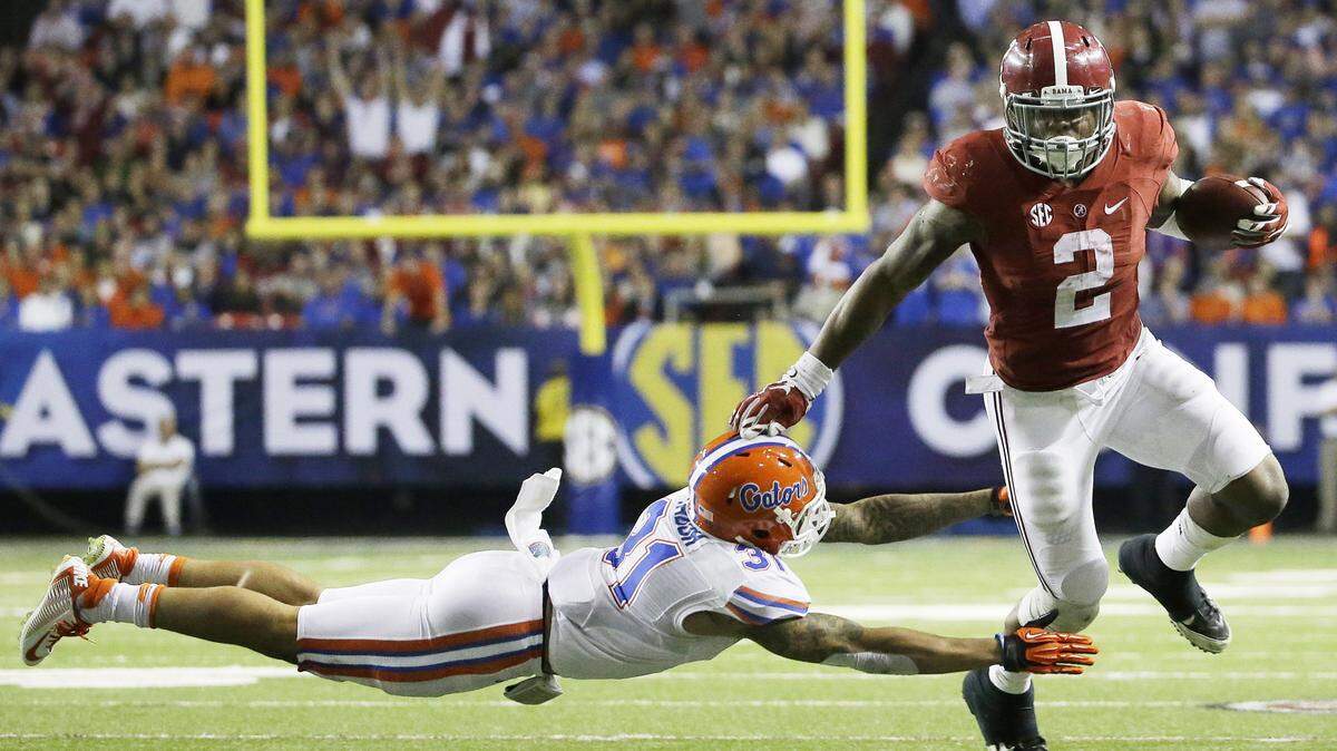 DAVID GOLDMAN/ASSOCIATED PRESS 
 Alabama running back Derrick Henry (2) runs by Florida defensive back Jalen Tabor (31) Saturday during the SEC championship Saturday in Atlanta.