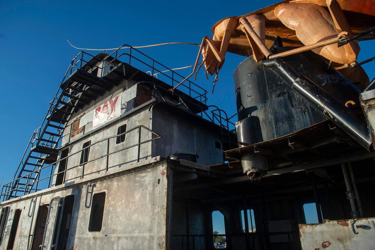 A giant steel cockroach on top of an old tugboat is docked in Biloxi on Thursday, Nov. 21, 2024. The boat and cockroach will be sunk in the Gulf of Mexico as an artificial reef that will attract fish, fishermen and divers.