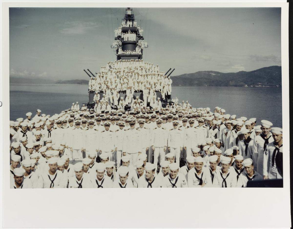 The USS Biloxi’s crew and officers during her shakedown period, October, 1943. They are posed on her forecastle and forward superstructure.