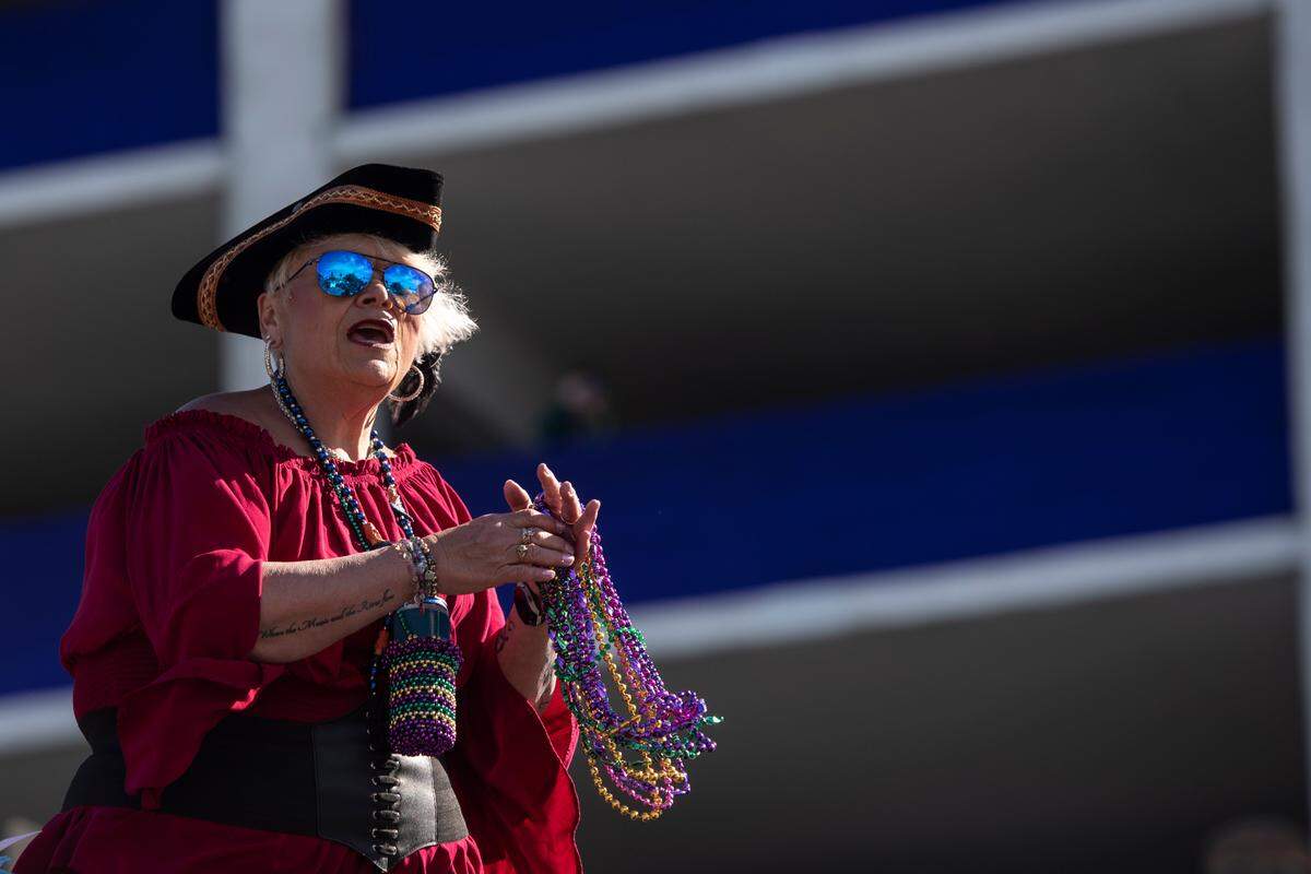 A float rider throws beads during the Gulf Coast Carnival Association’s Mardi Gras parade in Biloxi on Tuesday, Feb. 13, 2024.