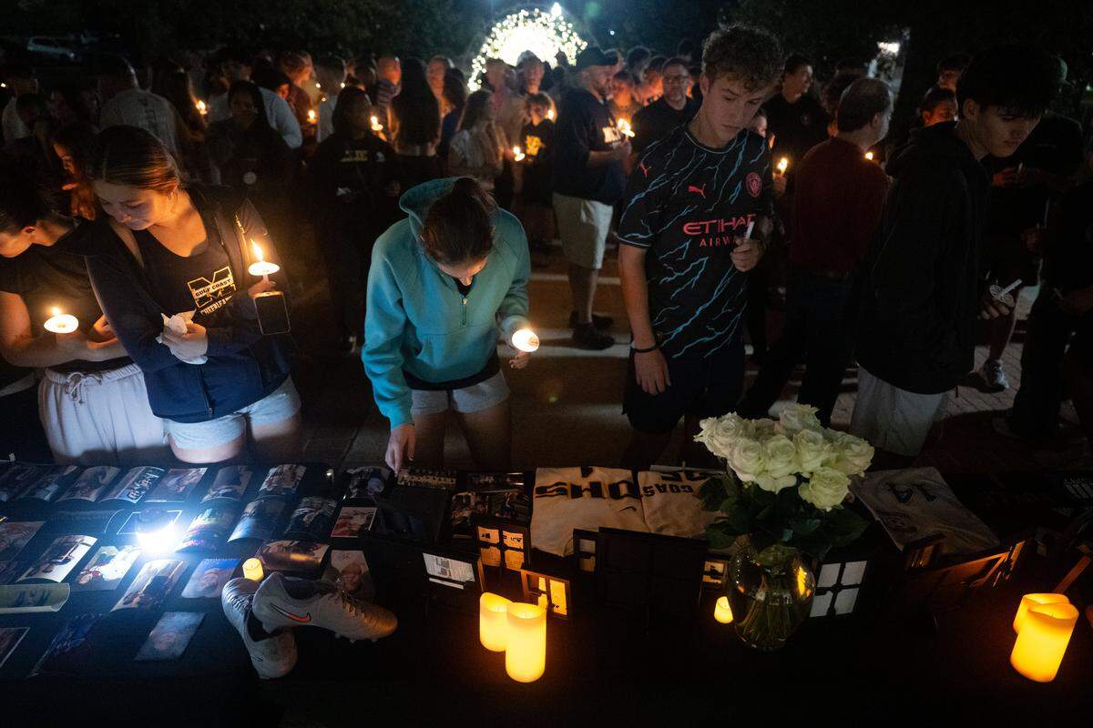 Attendees pay their respects Thursday during a candlelight vigil for Landon Perry at the Mississippi Gulf Coast Community College campus in Perkinston.