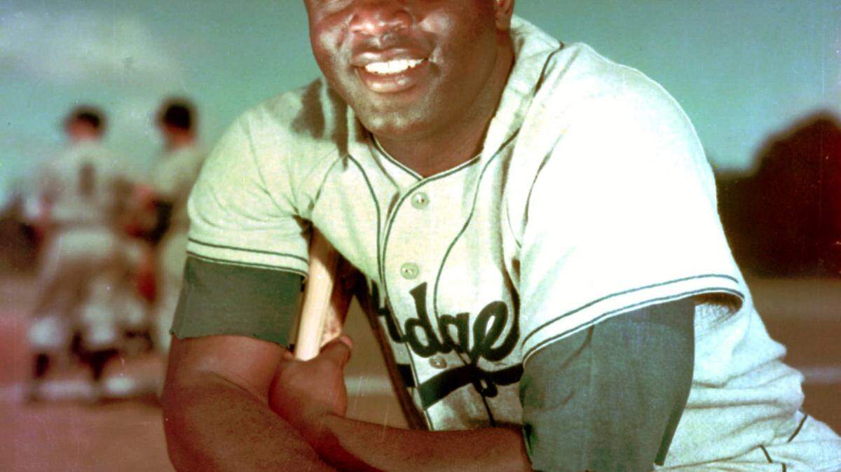 ASSOCIATED PRESS/FILE 
 Brooklyn Dodger infielder Jackie Robinson poses in May 1952.