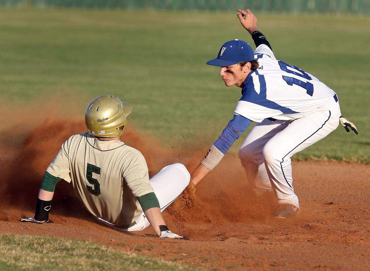 AMANDA McCOY/SUN HERALD  Vancleave shortstop Jacob Chappell attempts to tag out Poplarville's JJ Welch at second on Tuesday, March 12, 2013, at Vancleave High. Chappell threw a no-hitter over the weekend against Gautier.